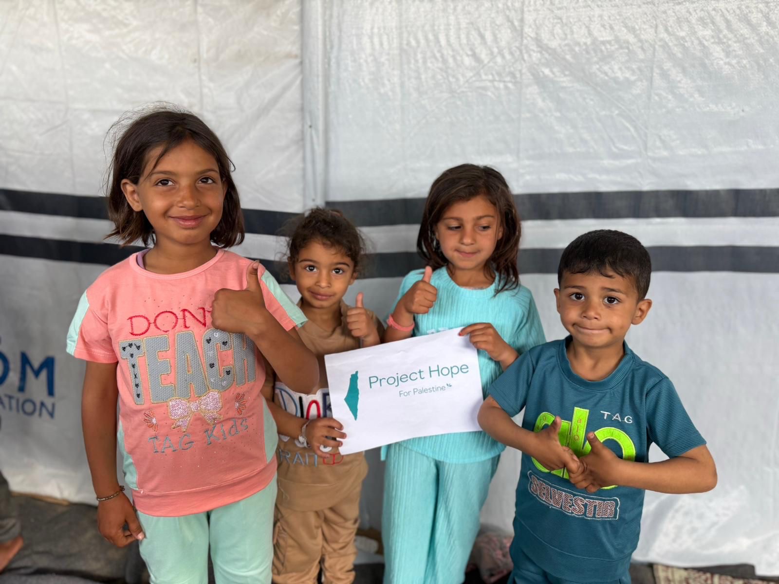 Children in Palestine with a Project Hope sign